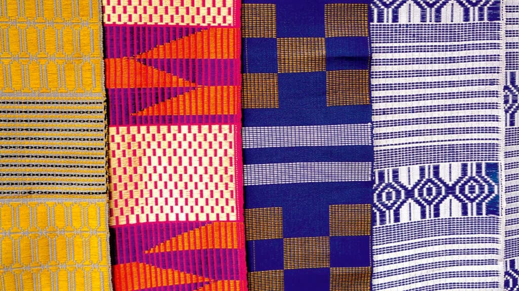 A woven Ghanaian kente cloth with colourful geometric patterns